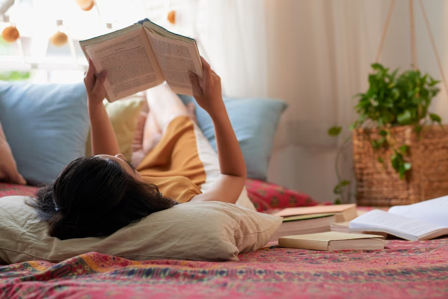 Girl reading book on floor