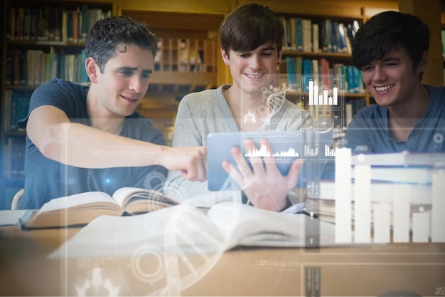 Young man pointing something out on tablet pc with others