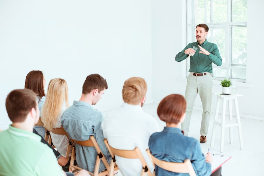 Man giving a talk to a crowd in a room