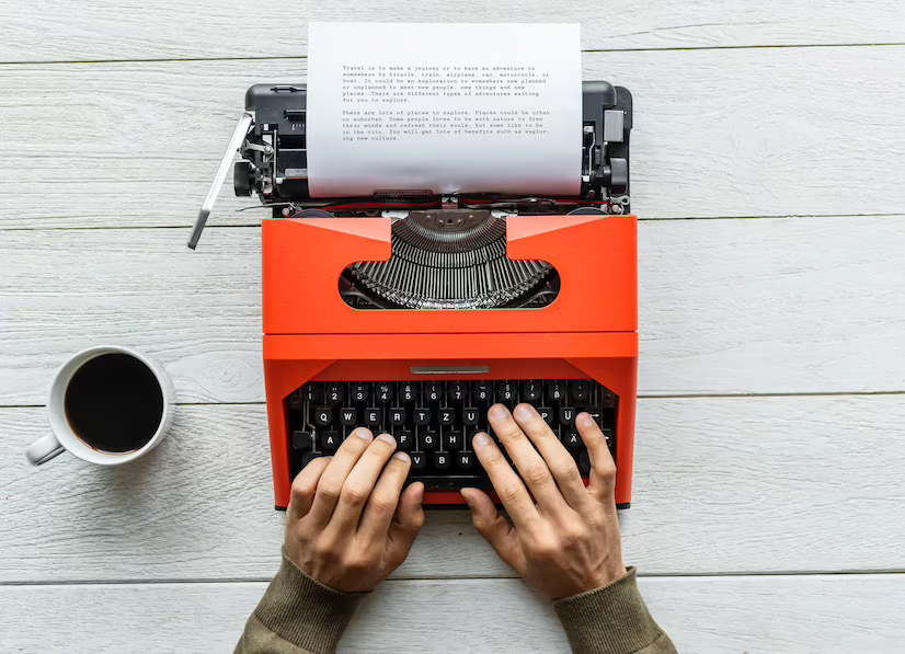 man typing on a retro typewriter